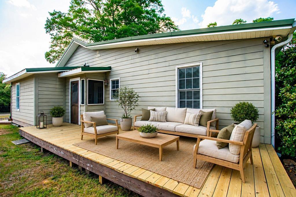 75 Cash Lane Bremen, GA 30110 - Photo 74 of 92 a view of a patio with couches table and chairs with wooden floor and fence