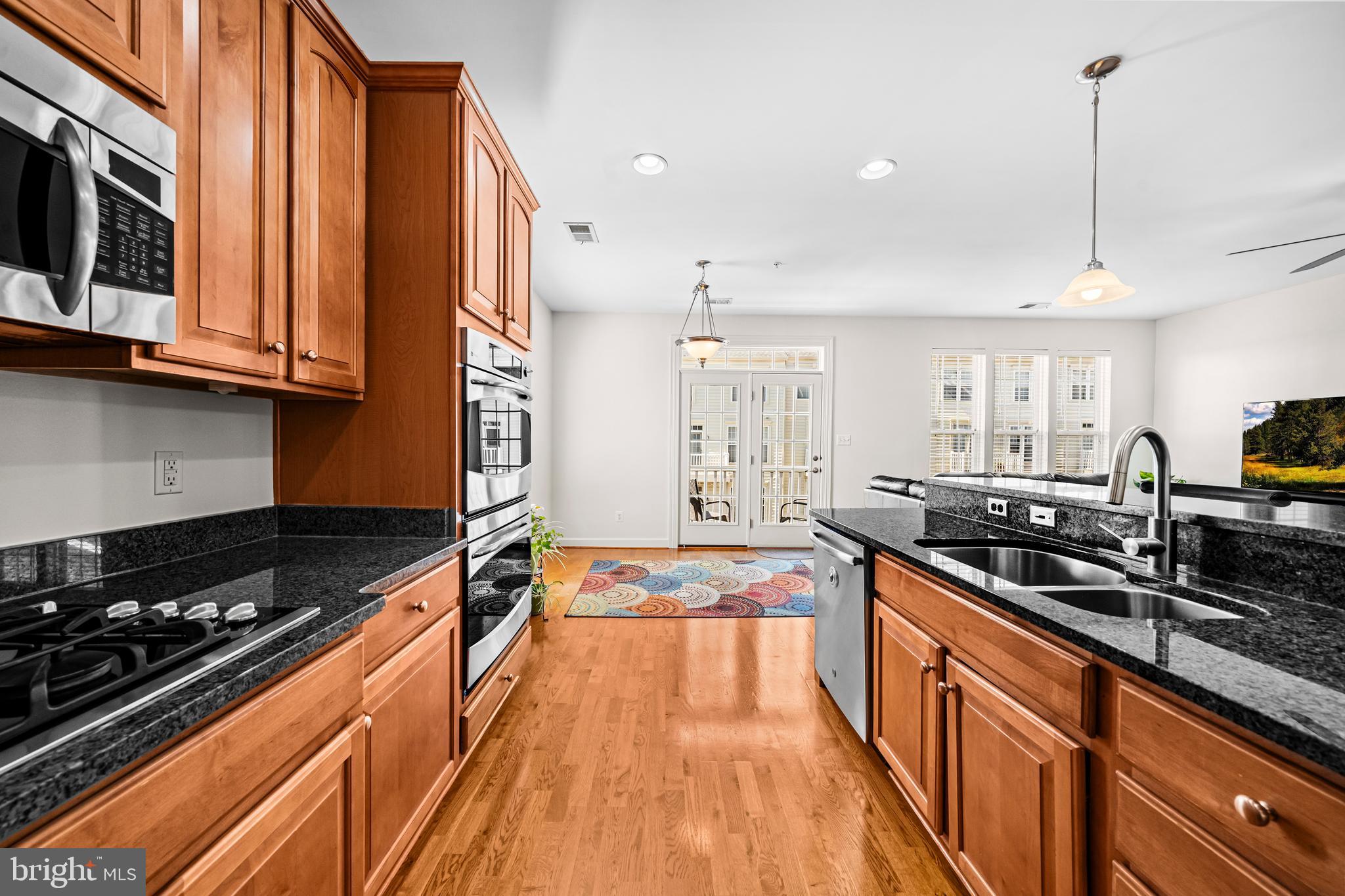 5725 Callcott Way, Unit P Alexandria, VA 22312 - Photo 12 of 40 a kitchen with stainless steel appliances a stove a sink a counter space and cabinets