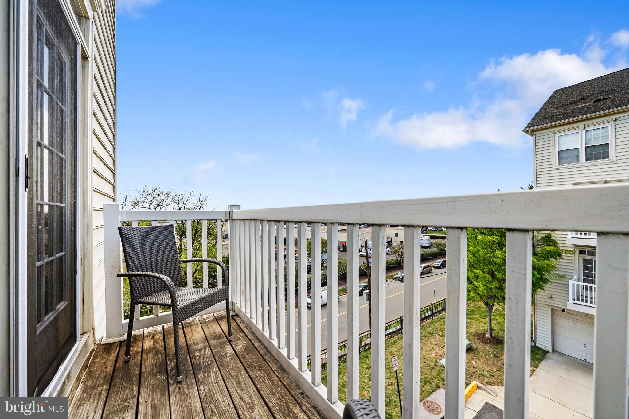 5725 Callcott Way, Unit P Alexandria, VA 22312 - Photo 18 of 40 a view of a balcony with wooden floor and iron fence