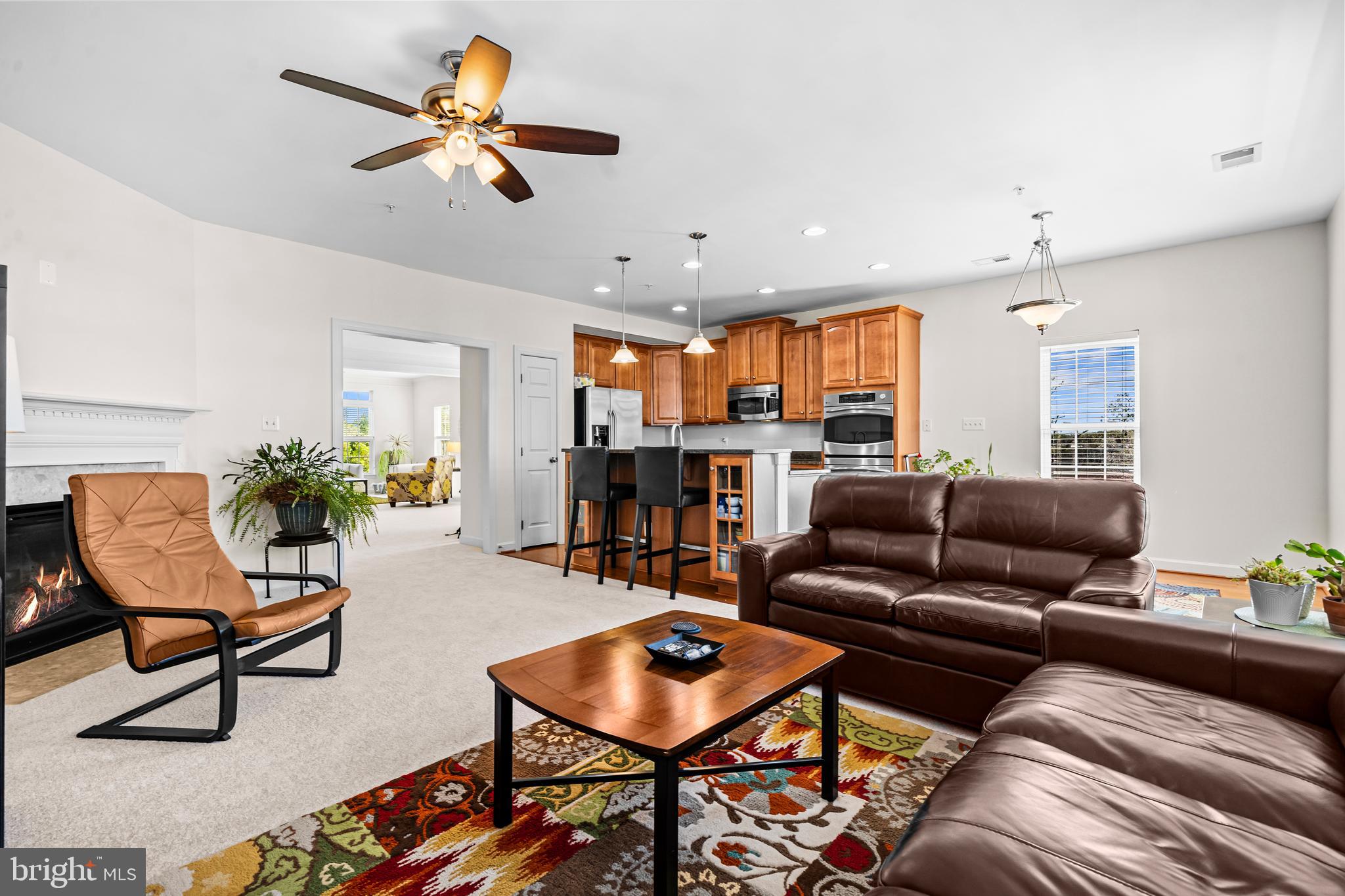 5725 Callcott Way, Unit P Alexandria, VA 22312 - Photo 19 of 40 a living room with furniture and a dining table with kitchen view