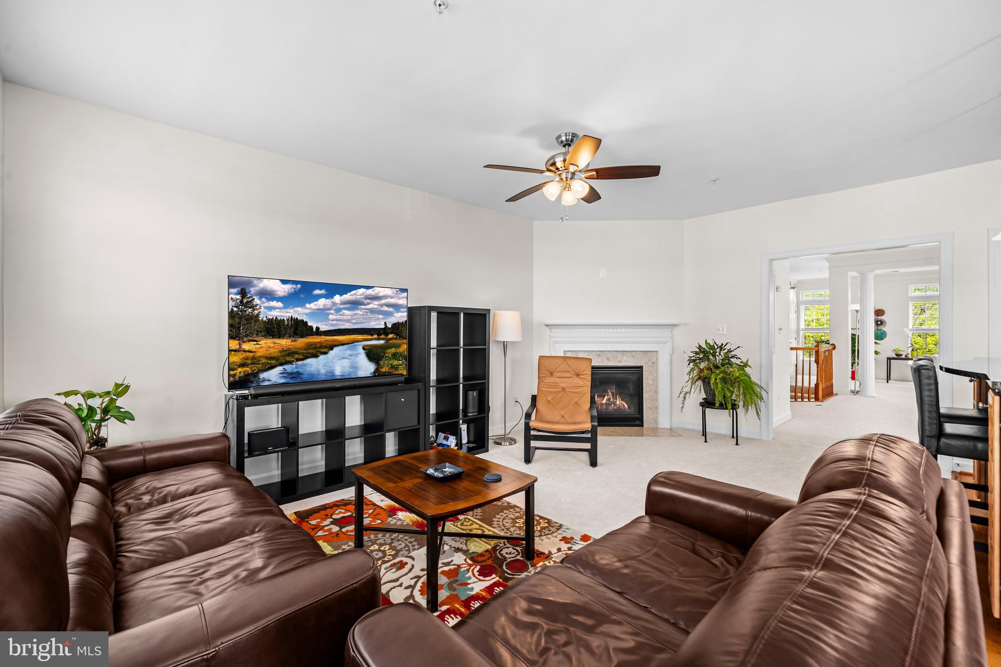 5725 Callcott Way, Unit P Alexandria, VA 22312 - Photo 20 of 40 a living room with furniture a flat screen tv and a fireplace