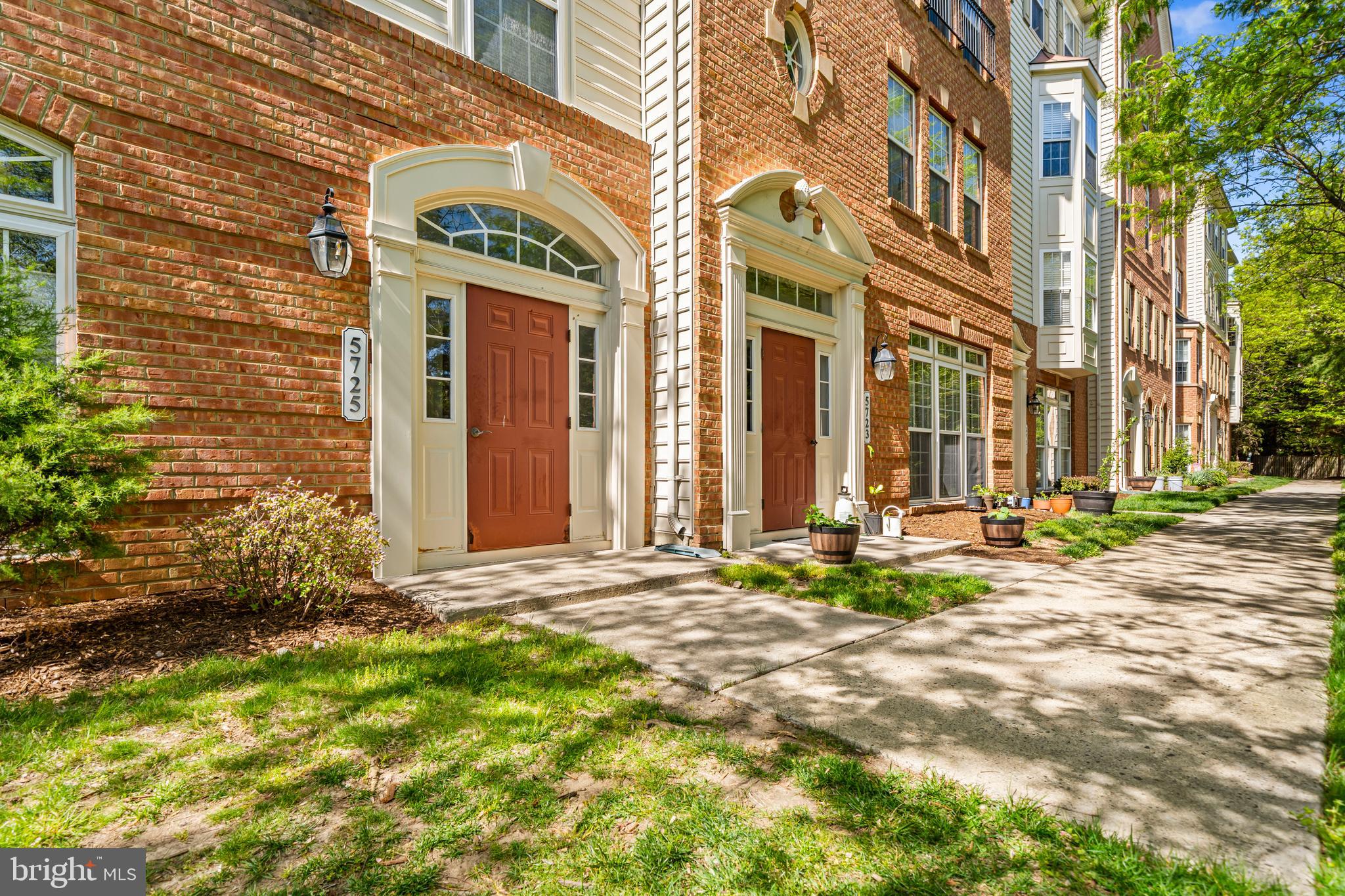 5725 Callcott Way, Unit P Alexandria, VA 22312 - Photo 2 of 40 a view of a brick building next to a yard