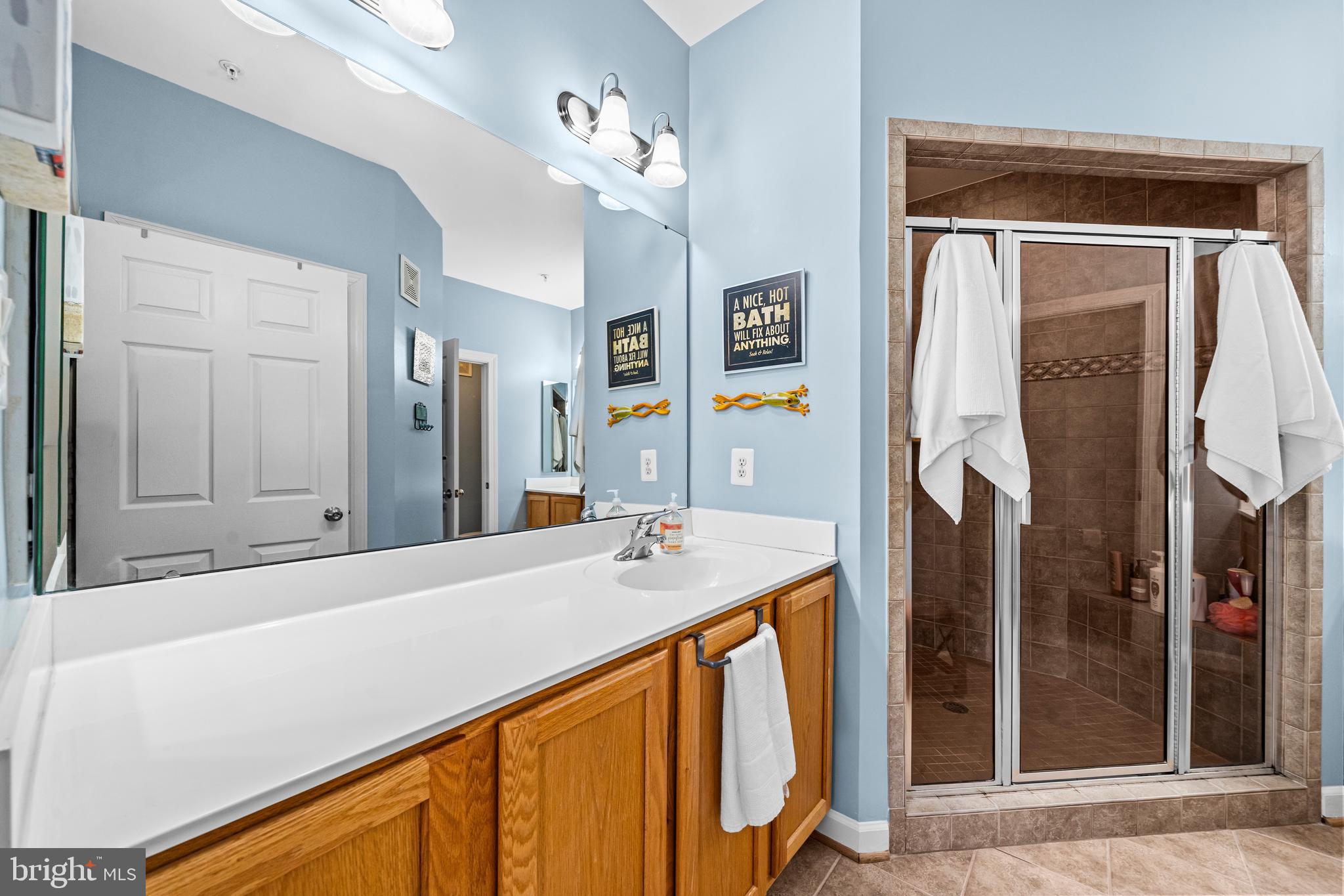 5725 Callcott Way, Unit P Alexandria, VA 22312 - Photo 28 of 40 a bathroom with a sink a mirror and a shower