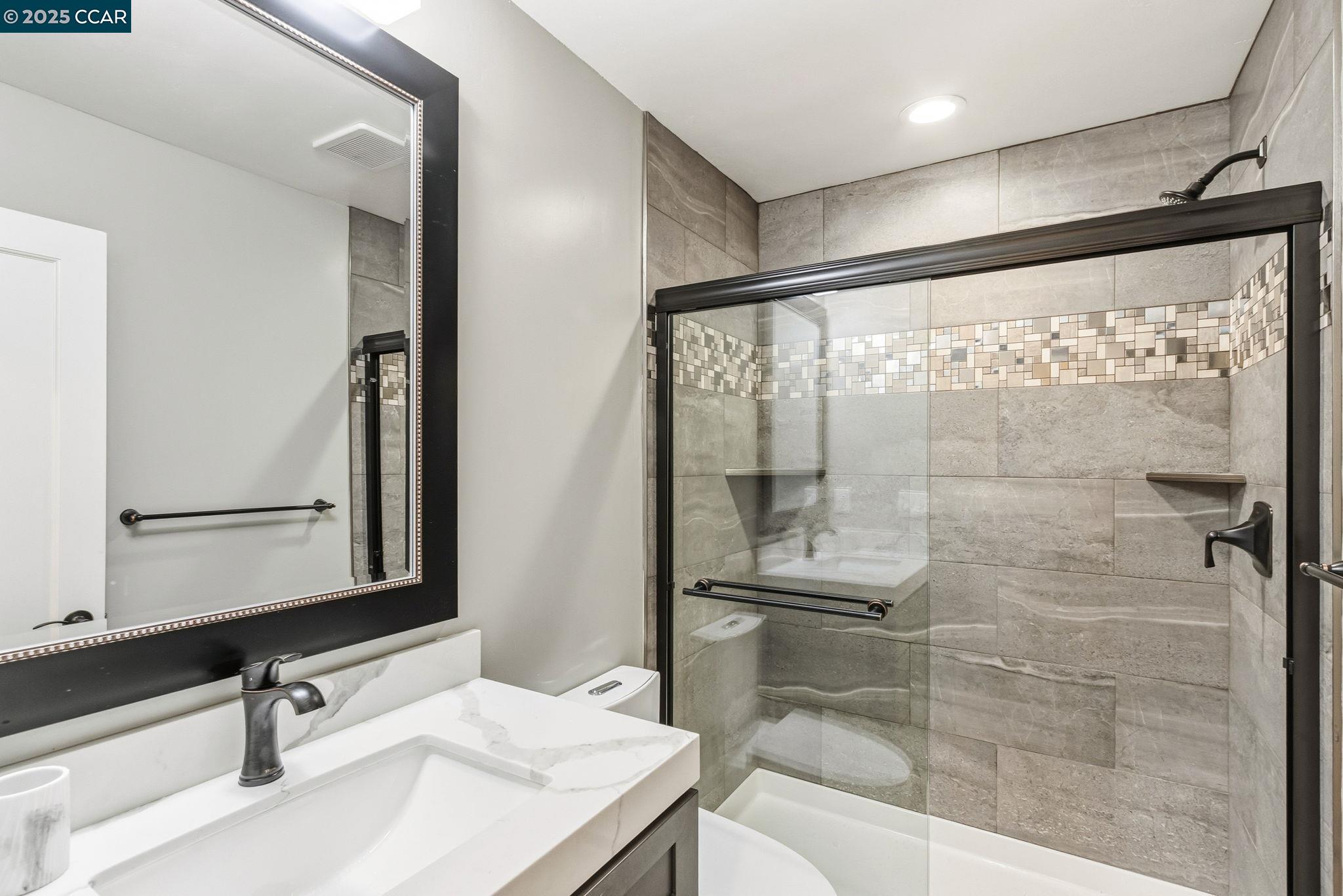 961 Oak View Circle Lafayette, CA 94549 - Photo 13 of 56 a bathroom with a shower sink and mirror