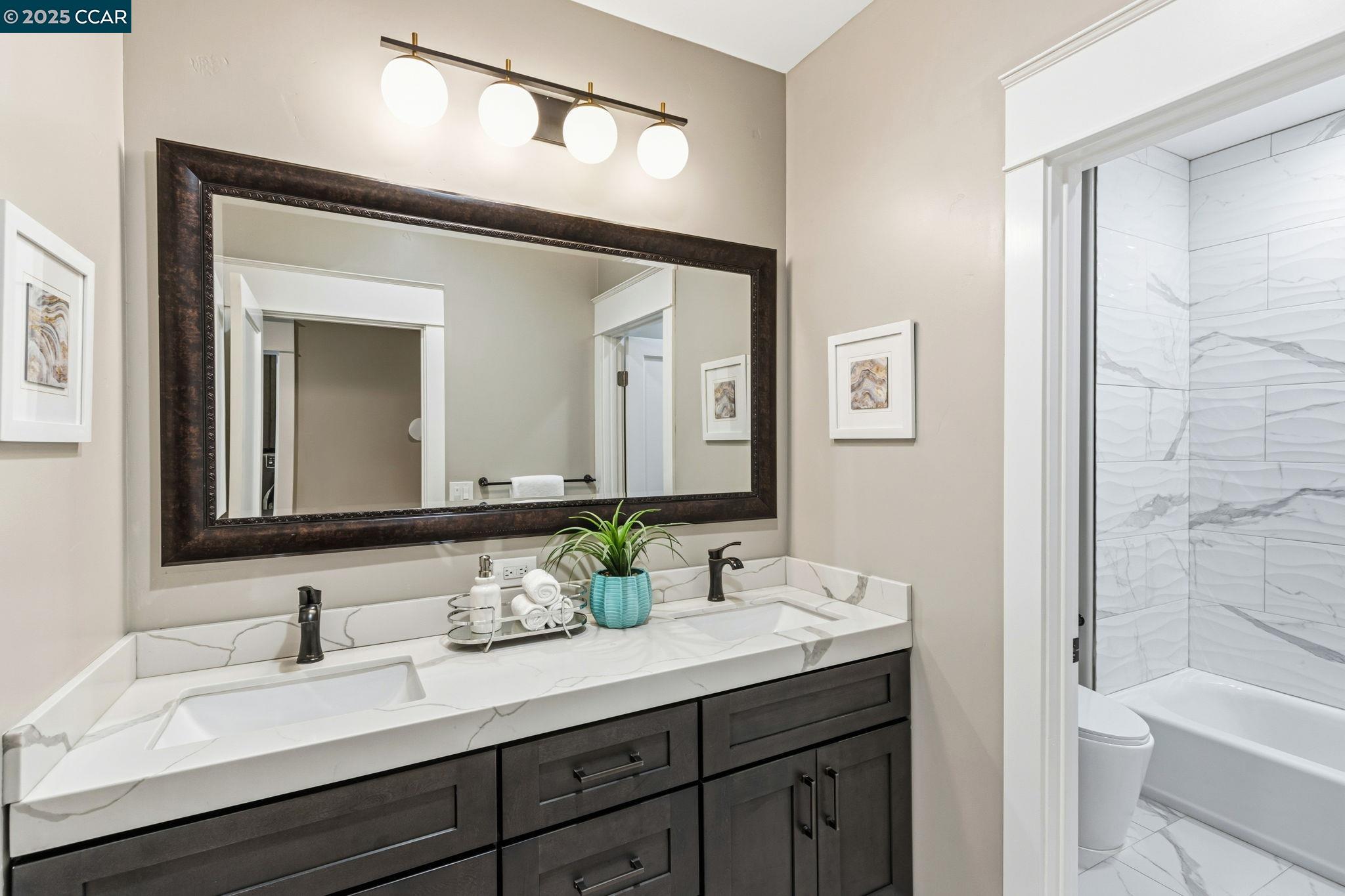 961 Oak View Circle Lafayette, CA 94549 - Photo 19 of 56 a bathroom with a double vanity sink and a mirror