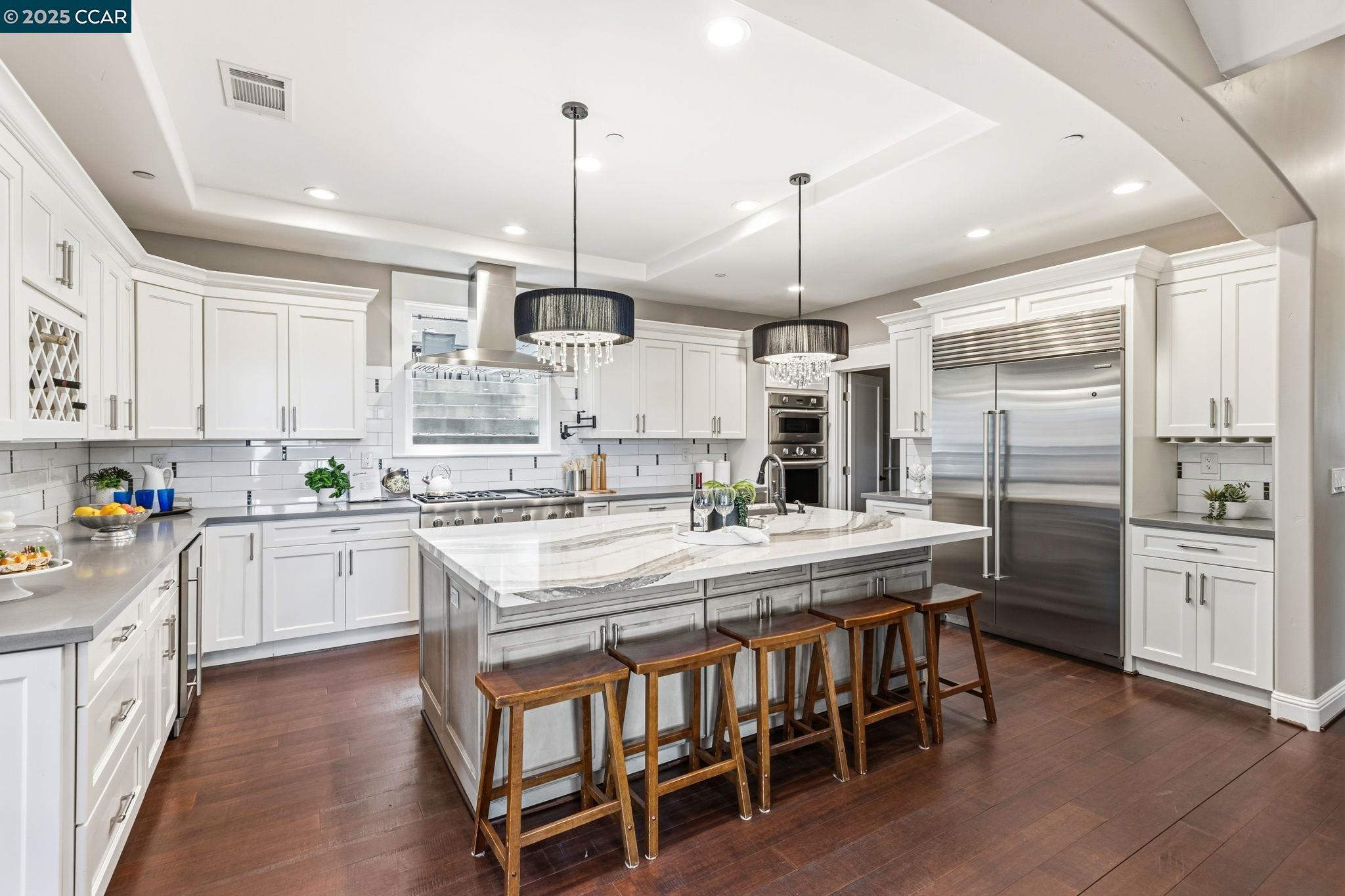 961 Oak View Circle Lafayette, CA 94549 - Photo 22 of 56 a kitchen with stainless steel appliances kitchen island granite countertop a table chairs sink and cabinets