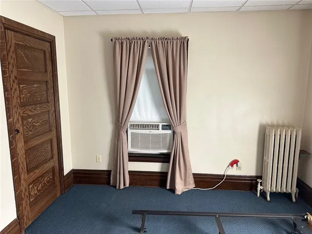 a view of a room with gym equipment and a window