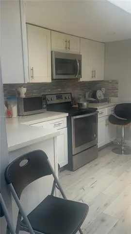 a kitchen with a stove and a microwave