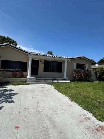 a front view of a house with a yard and a garage
