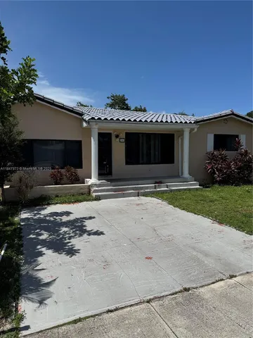a view of a house with cars in front of it