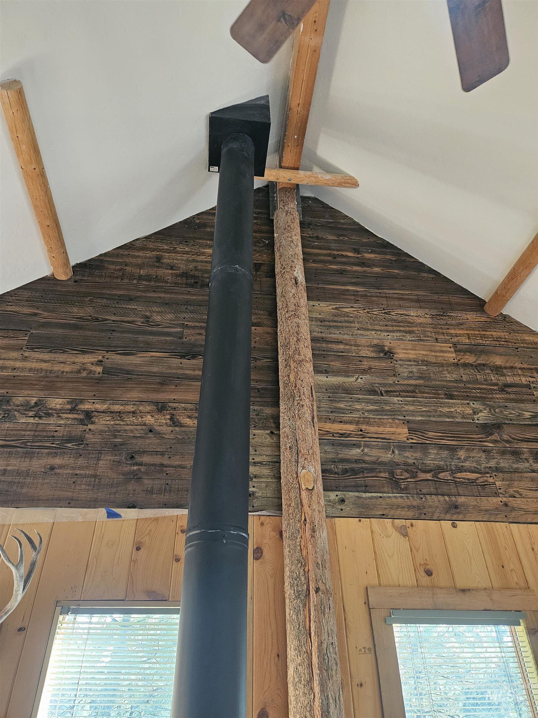 1510 Crown Point Parkway Cascade, ID 83611 - Photo 12 of 19 Detailed view of beamed ceiling, wood walls, and a wood stove