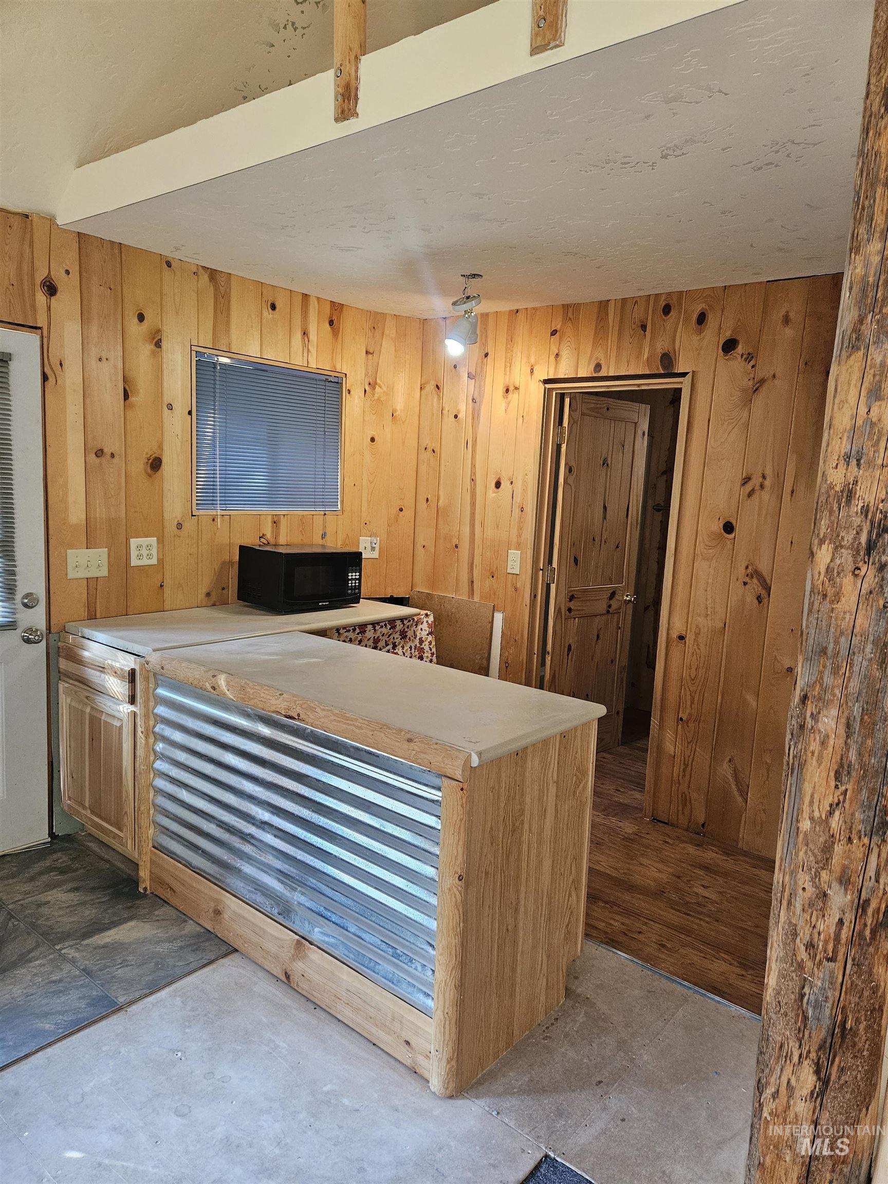 1510 Crown Point Parkway Cascade, ID 83611 - Photo 15 of 19 Kitchen with wood walls and black microwave