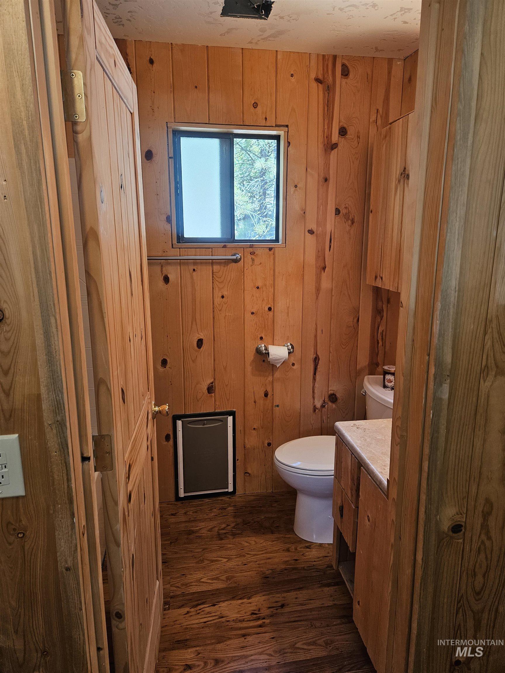 1510 Crown Point Parkway Cascade, ID 83611 - Photo 16 of 19 Bathroom featuring vanity, wood walls, and wood finished floors