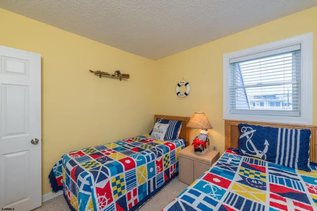 a bedroom with two beds and a dresser