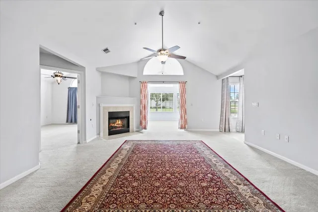 an empty room with windows and a fireplace