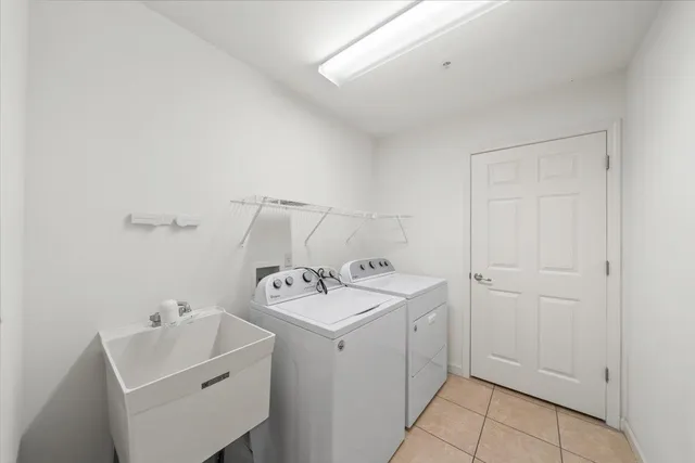 a view of a patio with couches and table and chairs with wooden floor and fence