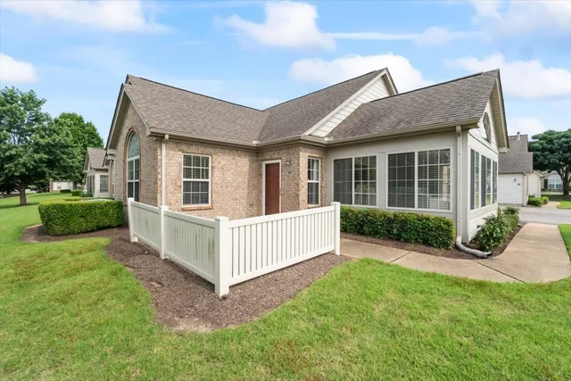 a view of a house with a yard and plants