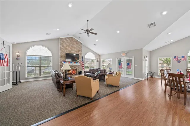 a living room with fireplace furniture and a wooden floor