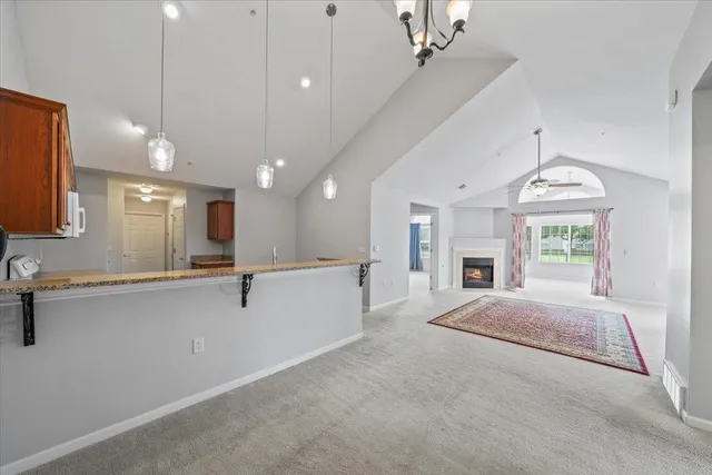 a large white building with kitchen view and a chandelier