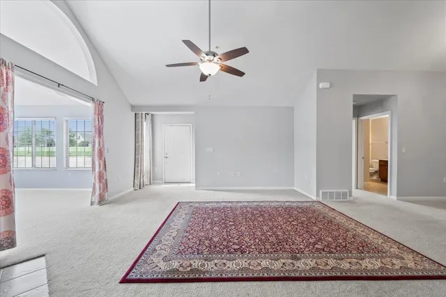 a view of a room with window and ceiling fan