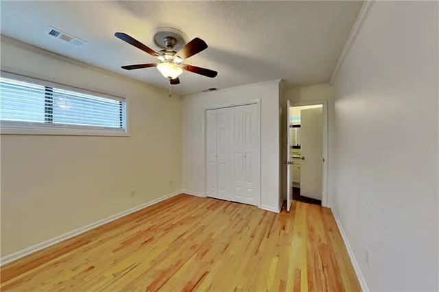 a view of empty room with wooden floor