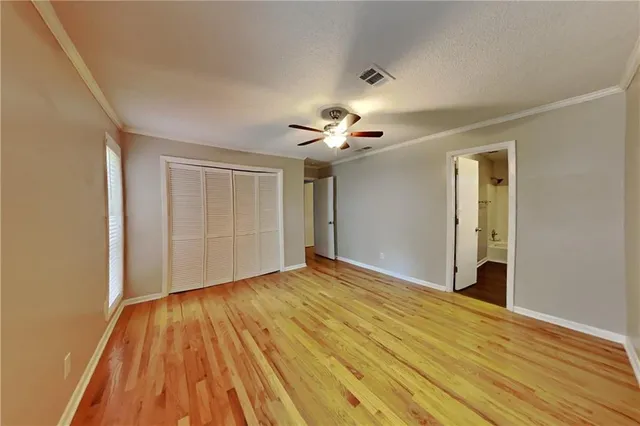 a view of an empty room and wooden floor
