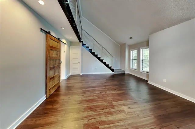 a view of an entryway with wooden floor