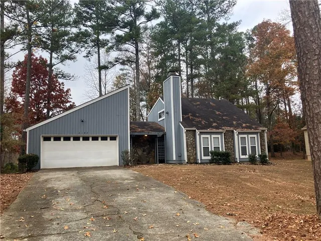 a front view of a building with a yard and garage