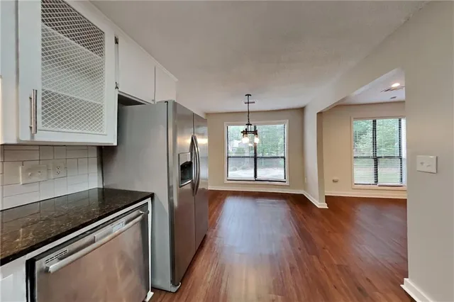 an empty room with wooden floor and a window