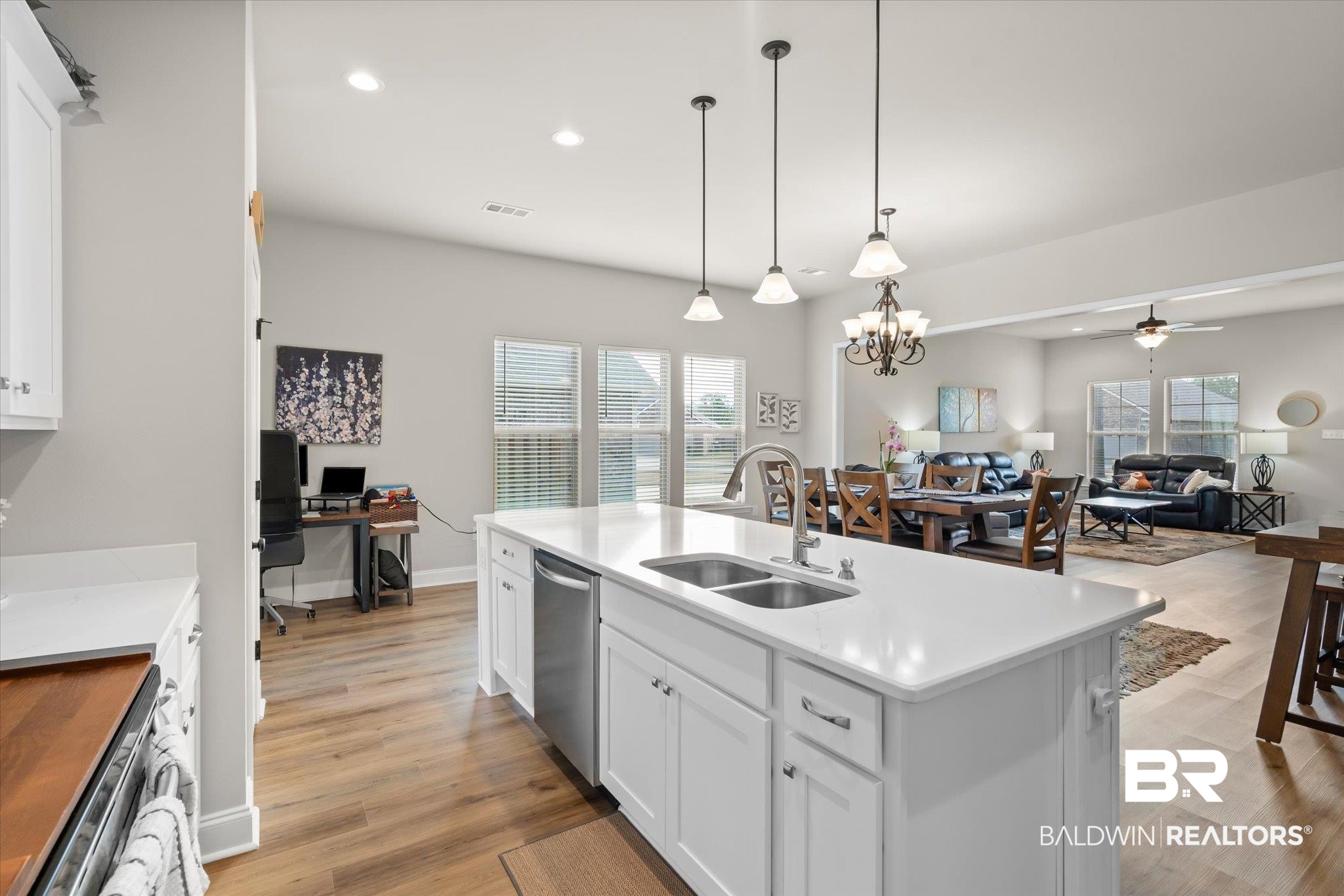 1116 Stella Road Foley, AL 36535 - Photo 10 of 29 Kitchen with white cabinets, an island with sink, sink, decorative light fixtures, and ceiling fan with notable chandelier