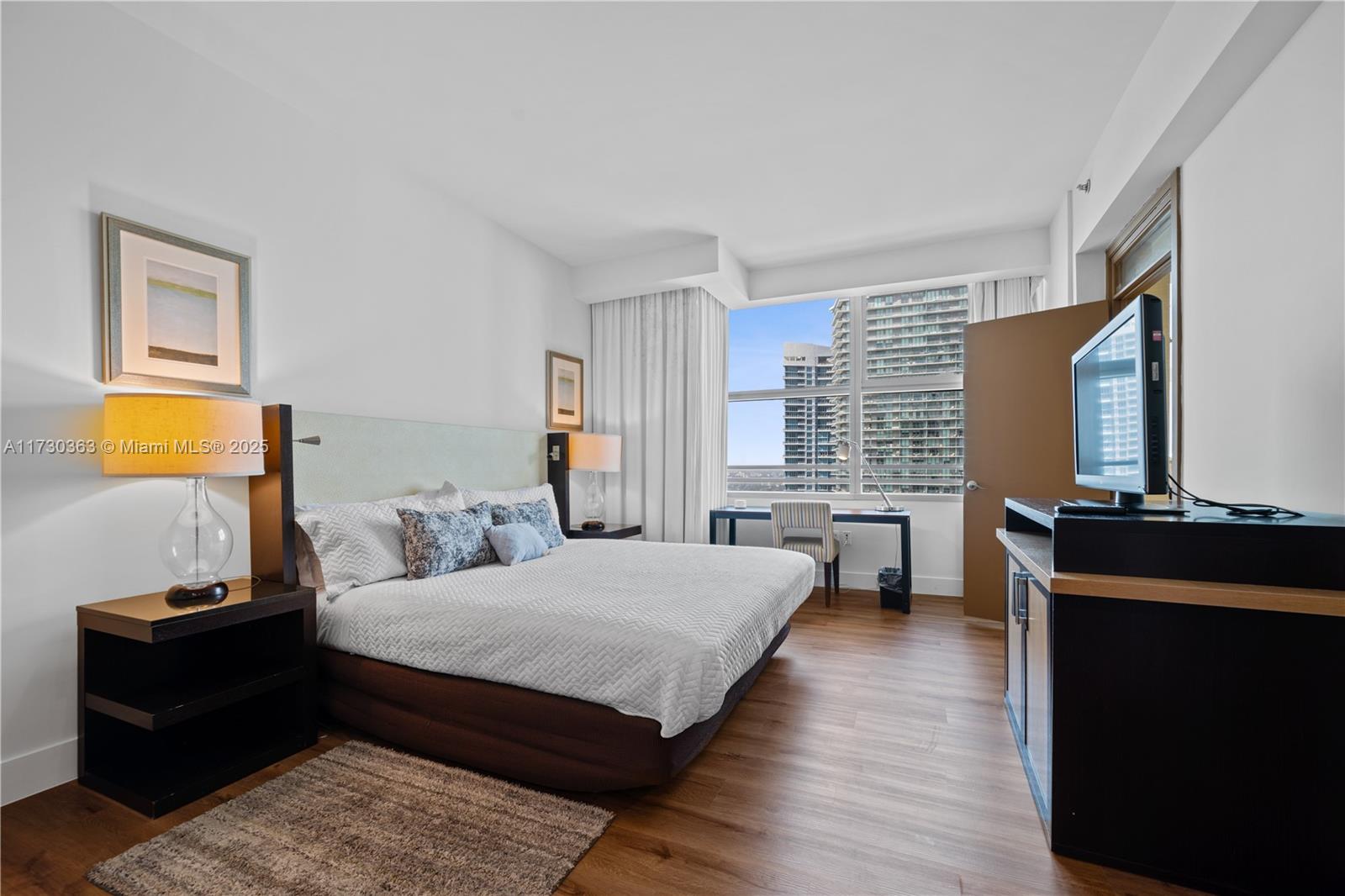 Brickell Miami, FL 33131 - Photo 13 of 19 a bedroom with a bed and wooden floor