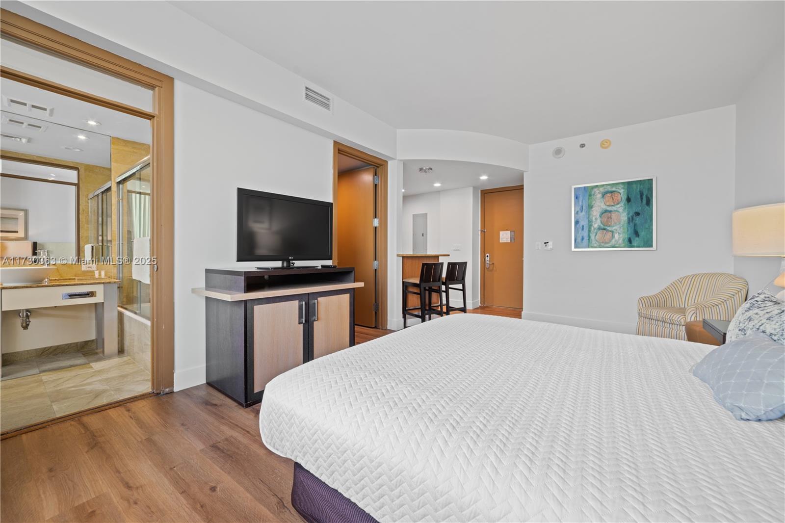 Brickell Miami, FL 33131 - Photo 14 of 19 a bedroom with a bed and a flat screen tv