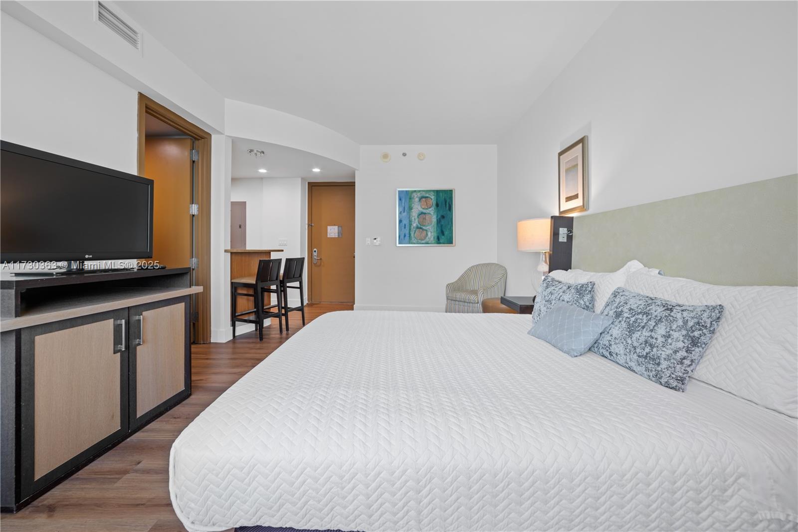 Brickell Miami, FL 33131 - Photo 15 of 19 a large white bed in a white room