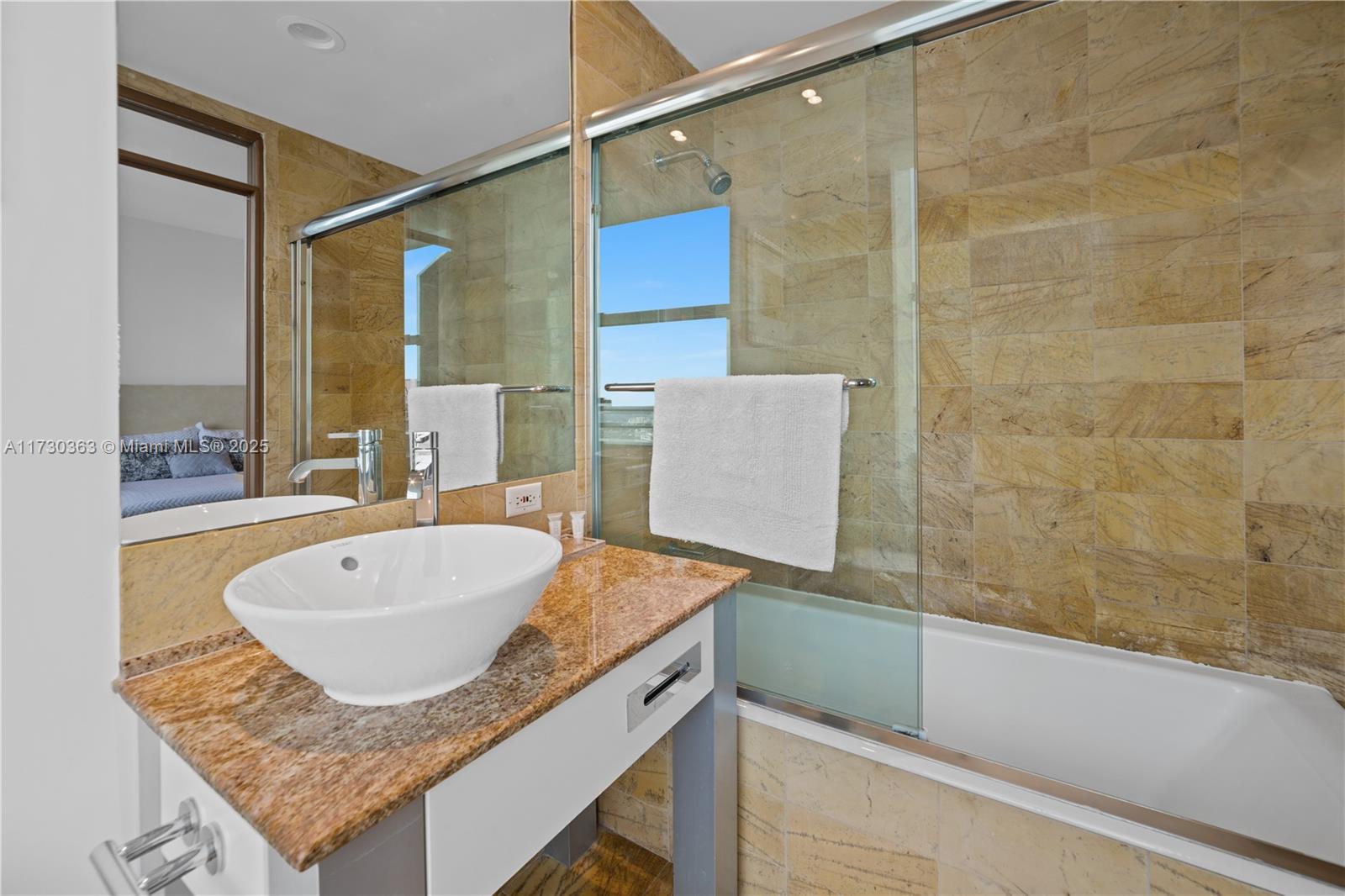 Brickell Miami, FL 33131 - Photo 18 of 19 a bathroom with a granite countertop sink and mirror