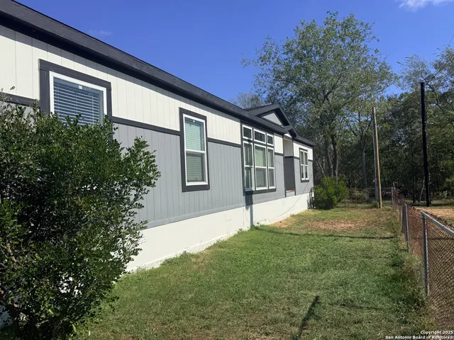 a backyard of a house with table and chairs