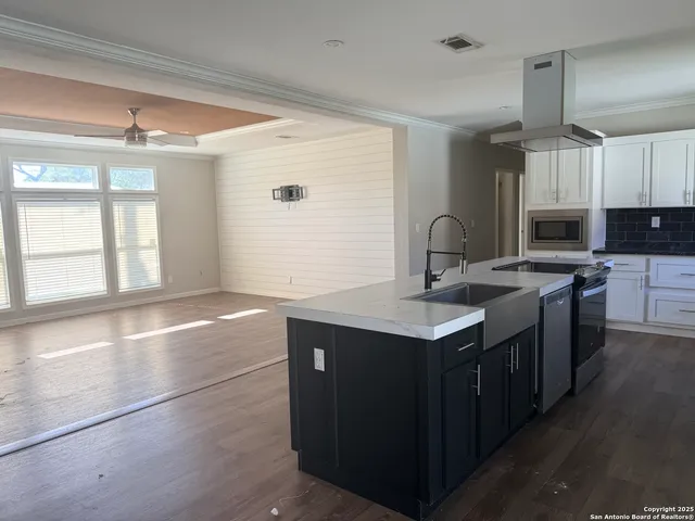 a kitchen with a sink stove and microwave