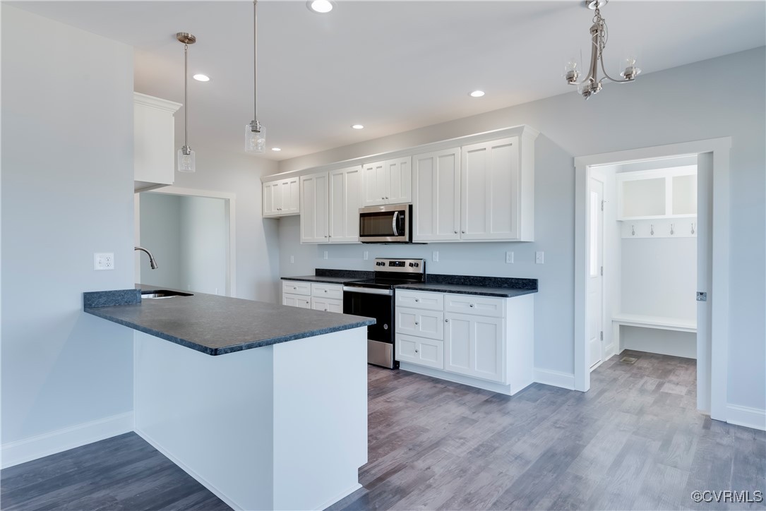 36 Highpockets Road Cartersville, VA 23027 - Photo 12 of 38 a kitchen with granite countertop appliances cabinets and a wooden floor