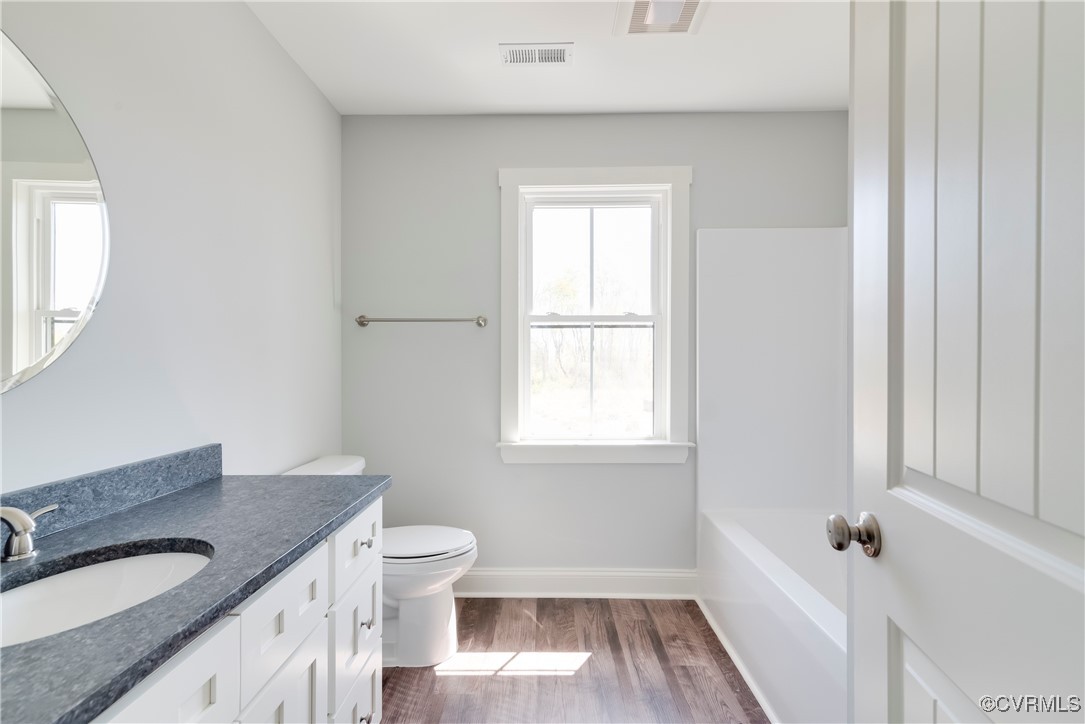 36 Highpockets Road Cartersville, VA 23027 - Photo 23 of 38 a bathroom with a granite countertop sink toilet a large mirror and shower