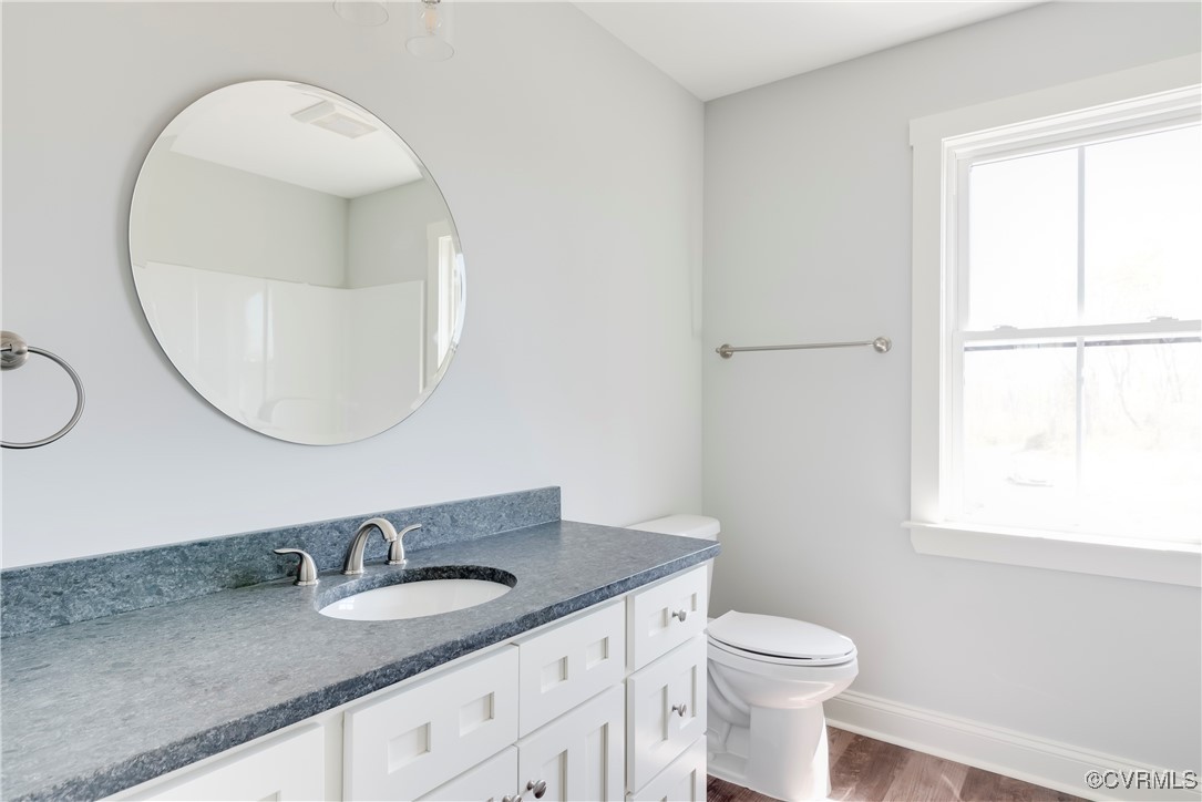 36 Highpockets Road Cartersville, VA 23027 - Photo 24 of 38 a bathroom with a granite countertop sink mirror vanity and toilet