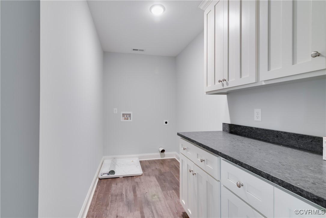 36 Highpockets Road Cartersville, VA 23027 - Photo 27 of 38 a kitchen with granite countertop white cabinets and a wooden floor