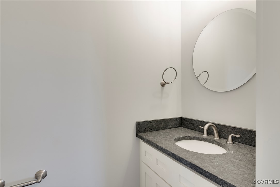 36 Highpockets Road Cartersville, VA 23027 - Photo 36 of 38 a bathroom with a granite countertop sink and a mirror