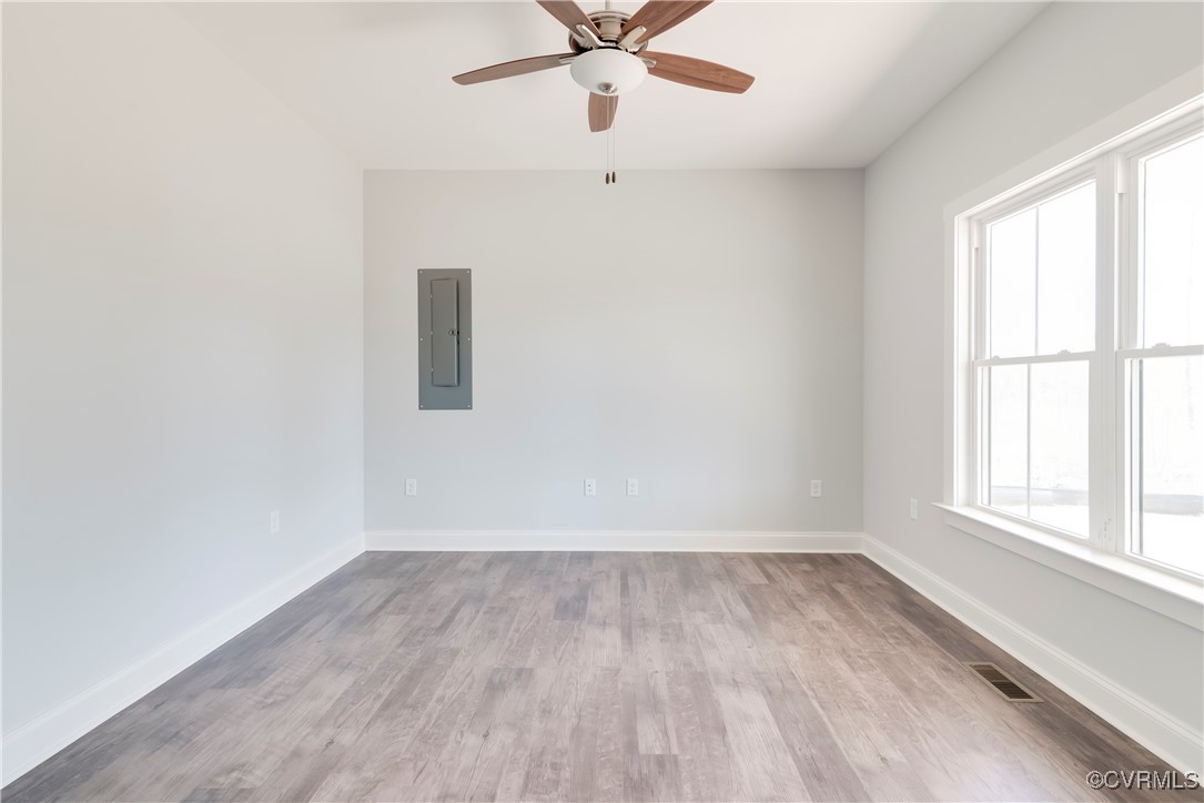 36 Highpockets Road Cartersville, VA 23027 - Photo 3 of 38 an empty room with wooden floor fan and windows