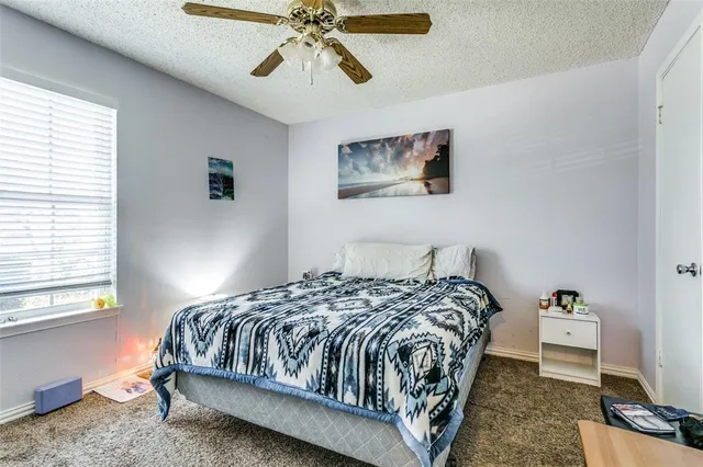 a bedroom with a bed and painting on the wall