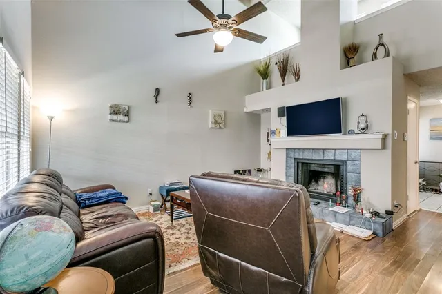 a living room with furniture a flat screen tv and a fireplace