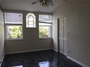 3313 Southeast 3rd Street Pompano Beach, FL 33062 - Photo 13 of 22 an empty room with wooden floor a chandelier and windows