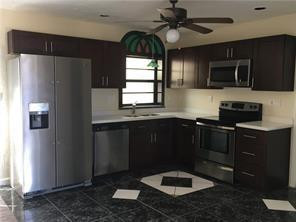 3313 Southeast 3rd Street Pompano Beach, FL 33062 - Photo 16 of 22 a kitchen with stainless steel appliances granite countertop a refrigerator a microwave a sink and a stove
