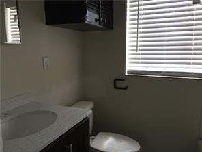 3313 Southeast 3rd Street Pompano Beach, FL 33062 - Photo 19 of 22 a bathroom with a toilet sink and window