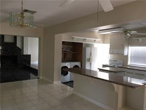 3313 Southeast 3rd Street Pompano Beach, FL 33062 - Photo 3 of 22 a kitchen with a sink and chandelier
