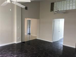 3313 Southeast 3rd Street Pompano Beach, FL 33062 - Photo 4 of 22 an empty room with wooden floor and cabinet