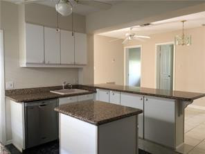 3313 Southeast 3rd Street Pompano Beach, FL 33062 - Photo 6 of 22 a kitchen with a granite countertop sink and cabinets